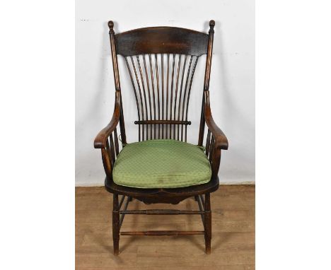 Early 20th century Arts and Crafts oak stick back elbow chair, once owned by the prominent gardener Russell Page (1904-1985).