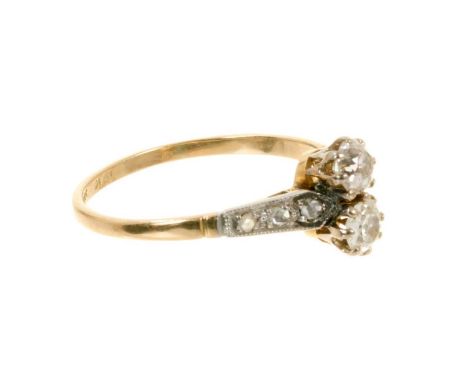 Antique diamond two stone ring with two old cut diamonds estimated to weigh approximately 0.30cts in total, flanked by rose c