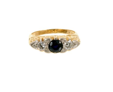 Victorian style sapphire and diamond three stone ring with a round mixed cut blue sapphire flanked by two brilliant cut diamo