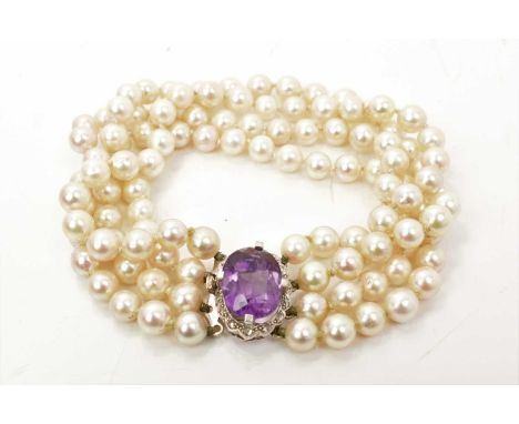 Cultured pearl four strand bracelet with an amethyst and diamond set oval clasp, 20.5cm longGood condition commensurate with 
