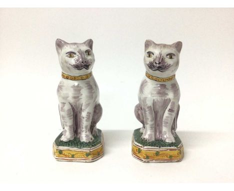 Pair of Dutch delftware cats, 19th/20th century, modelled seated on octagonal bases, polychrome painted, with 'AK' marks to b