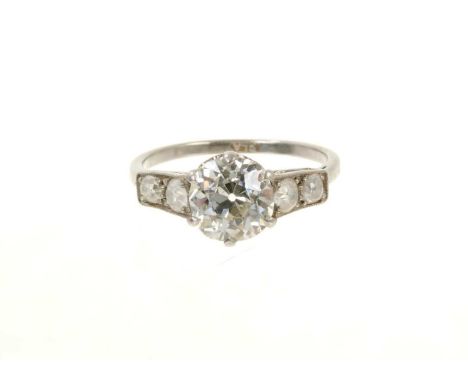 Fine 1930s diamond ring the central old cut diamond estimated to weigh approximately 2.16cts, in six claw setting flanked by 