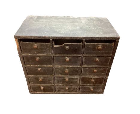 Early 20th century scratch built nest of fifteen small drawers, all with brass knobs, made out of Bovril boxes. Advertising s