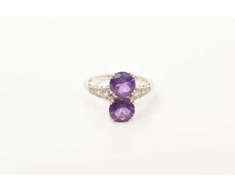 Amethyst and diamond ring with two round mixed cut amethysts flanked by diamond set shoulders on 18ct white gold shank, ring 