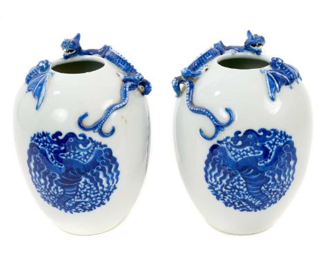 Pair of Chinese blue and white vases, 20th century, of ovoid form, moulded with dragons and bats, painted with archaic-style 