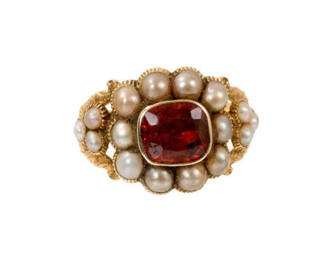 Regency gold ring with a central cushion shaped garnet surrounded by ten half pearls and three further half pearls set to eac