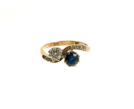 Edwardian diamond and sapphire two stone cross over ring with an old cut diamond estimated to weigh approximately 0.40carats 