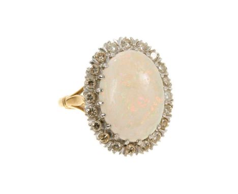 Opal and diamond cluster ring with an oval opal cabochon measuring approximately 17.5mm x 12.8mm surrounded by a border of br