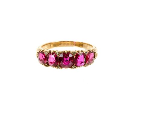 Late Victorian ruby five stone ring with five graduated oval mixed cut rubies with diamond accents to the claw in 18ct gold s