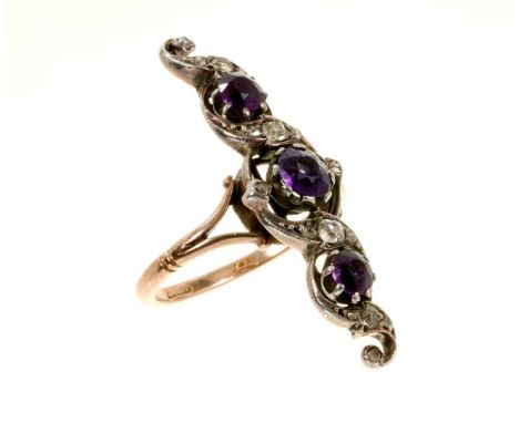 Edwardian amethyst and diamond ring with a finger-line scrolling openwork foliage with amethysts and diamonds in silver setti