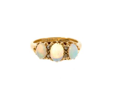 Edwardian opal and diamond ring with three oval cabochon opals interspaced by four diamonds in gold claw setting on 18ct gold