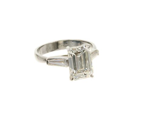 A fine diamond single stone ring with an emerald cut diamond weighing approximately 3.06cts, estimated I/J colour and estimat