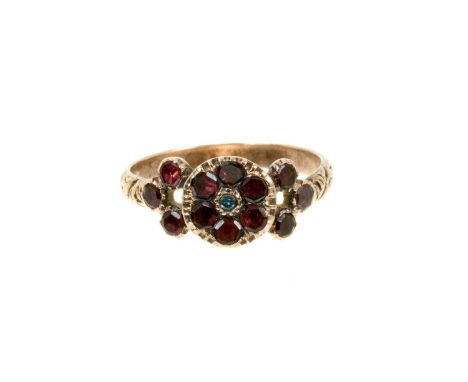 Georgian garnet cluster ring, the flower head cluster with six flat cut garnets and three further garnets to each shoulder in