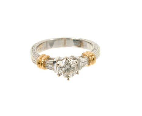 Diamond single stone ring with a brilliant cut diamond estimated to weigh approximately 0.60cts flanked by tapered baguette c