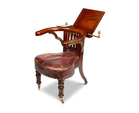 A George IV carved mahogany reading / library chair attributed to Morgan &amp; Saunders
The bowed arms with rolling ratcheted