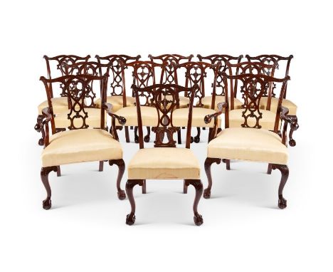 A set of twelve early 20th century Chippendale style carved mahogany dining chairs including pair of open armchairs The serpe