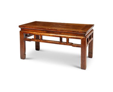 A 19th century Chinese elm low table
The rectangular cleated top above a pierced frieze, on square legs and scroll feet, 91cm