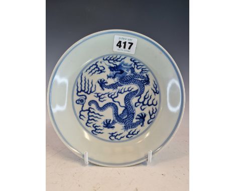 A CHINESE BLUE AND WHITE PLATE PAINTED WITH A DRAGON CHASING A FLAMING PEARL, SIX CHARACTER MARK.   Dia. 17cms