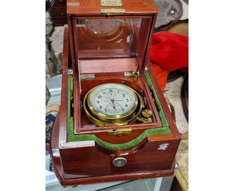 A RUSSIAN MARINE CHRONOMETER WITHIN DOUBLE WOODEN CASES OF MAHOGANY STAINED WOOD, THE DIAL BEZEL. Dia.12cms.