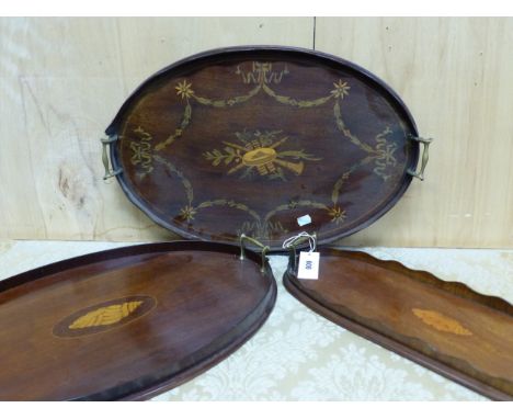 THREE MAHOGANY GALLERIED TWO HANDLED TRAYS, TWO INLAID WITH CENTRAL CONCH SHELLS AND THE THIRD WITH A MUSICAL TROPHY