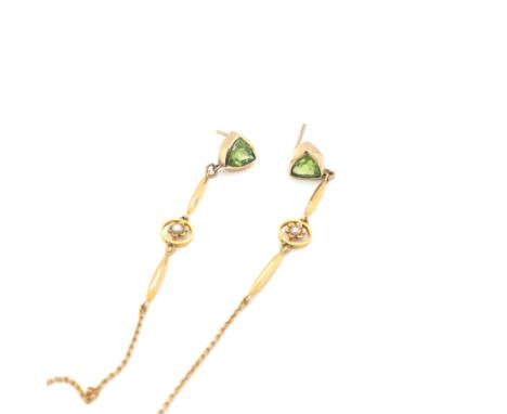 A PAIR OF PERIDOT AND SEED PEARL DROP EARRINGS. THE PERIDOT STUD EARRINGS SET IN UNHALLMARKED RUB OVER STYLE SETTING ASSESSED