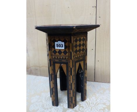 AN ISLAMIC MINIATURE HEXAGONAL TABLE, THE TOP INLAID WITH EBONY AND MOTHER OF PEARL TRIANGLES ABOUT A CENTRAL STAR.   W 21.5 