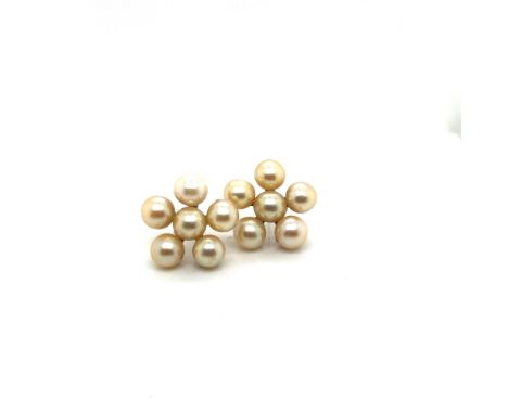 A PAIR OF DAISY STYLE PEARL EARRINGS. THE SETTINGS UNHALLMARKED, ASSESSED AS 10ct GOLD. APPROX PEARL MEASUREMENT 7.3-8.0mm. G