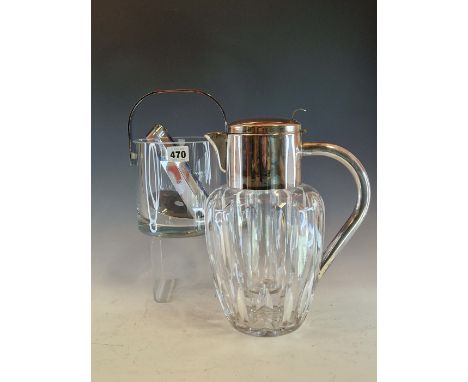 AN ORREFORS CYLINDRICAL GLASS ICE BUCKET WITH CHROME HANDLE, LINER AND TONGS TOGETHER WITH A CHROME MOUNTED LEMONADE JUG WITH