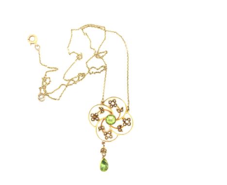 AN EDWARDIAN PERIDOT AND SEED PEARL FOLIATE WREATH STYLE PENDANT, WITH A SUSPENDED PERIDOT AND PEARL DROP, COMPLETE WITH AN A