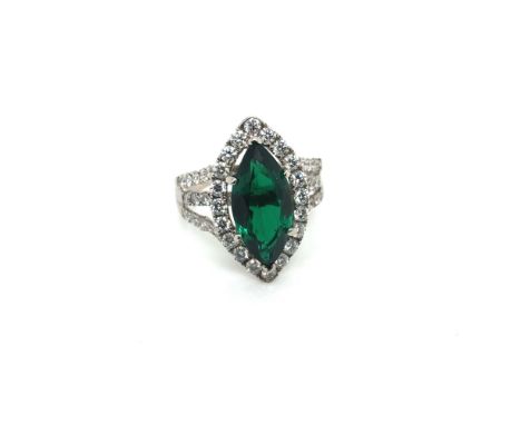 AN 18ct HALLMARKED WHITE GOLD EMERALD AND DIAMOND MARQUISE RING. THE EMERALD IN A RAISED SIX CLAW SETTING, APPROX MEASUREMENT