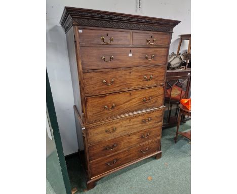 A GEORGE III MAHOGANY SECRETAIRE CHEST WITH A BLIND FRET BAND BELOW THE CORNICE AND ABOVE TWO SHORT, TWO LONG, THE SECRETAIRE