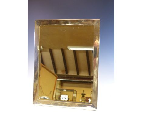 AN EASEL BACKED SILVER FRAMED BEVELLED GLASS MIRROR, LONDON HALL MARKS WORN.   43.5 x 33cms.