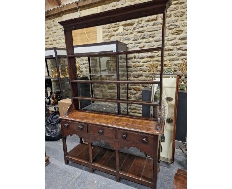 A 19th C. OAK DRESSER, THE OPEN THREE SHELF BACK OVER A BASE WITH THREE DRAWERS, ARCHED APRON AND A POT BOARD.   W 145 x D 42