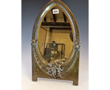 A WMF ELECTROPLATE EASEL BACKED MIRROR, THE EGG SHAPED BEVELLED GLASS FLANKED BY FLOWERS ABOVE THREE PUTTI.   50 x 28cms.