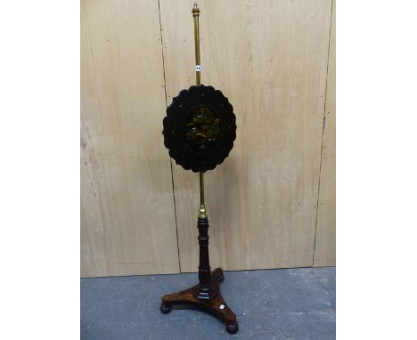 A VICTORIAN ROSEWOOD AND BRASS POLE SCREEN, THE SHAPED ROUND PAPIER MACHE SCREEN INLAID WITH MOTHER OF PEARL AND GILT WITH CH