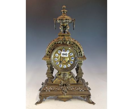 A 19th C. FRENCH BRASS MANTLE CLOCK SURMOUNTED BY A RING HANDLED URN, THE DIAL WITH ENAMEL NUMERAL SHIELDS, THE JAPY FRERES M