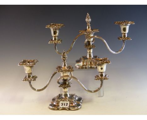 A PAIR OF PLATE ON COPPER THREE LIGHT CANDELABRA WORKED WITH BANDS OF LEAVES ABOVE THE SHAPED SQUARE FEET.   H 19cms.