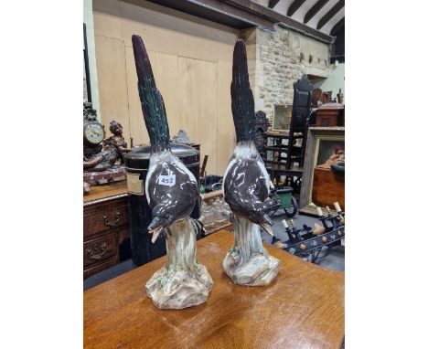 A PAIR OF MEISSEN FIGURES OF MAGPIES CALLING FROM TREE TRUNK PERCHES, CROSSED SWORDS MARKS.   H 52cms.