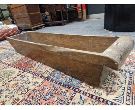 A HOLLOWED OUT TREE TRUNK RECTANGULAR TROUGH, POSSIBLY TEAK.   W 141 x D 31.5 x H 25cms. 