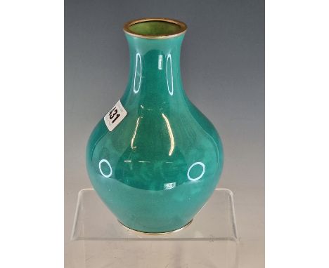 ATTRIBUTED TO INABA, A MUSEN ENAMEL BOTTLE VASE WORKED WITH A BAND OF FLOWERS ON A GREEN GROUND.   H 18.5cms.