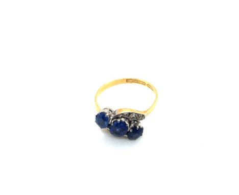 A VINTAGE GEMSET AND DIAMOND OVAL THREE STONE TWIST RING. UNHALLMARKED, STAMPED 18ct &amp; PLAT. FINGER SIZE P. WEIGHT 3.20gr