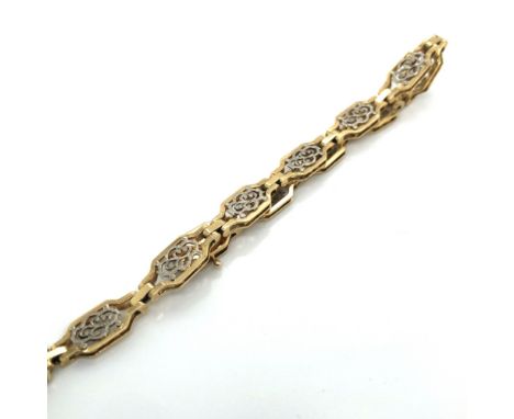 A FILIGREE ELEVEN PANEL TWO COLOUR LADIES BRACELET. UNHALLMAKRED, STAMPED 585, ASSESSED AS 14ct GOLD. LENGTH 17cms. WEIGHT 7.