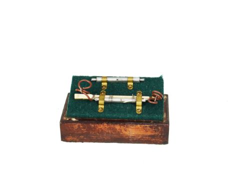 Two coherers: one mounted on stick (crack in glass), in a display case 