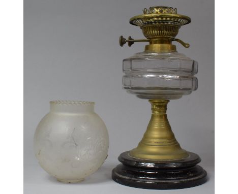 A Late 19th/Early 20th Century Oil Lamp with Glass Reservoir and Ceramic Base, 31cms High together with a Glass Shade 