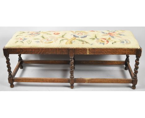 An Edwardian Oak Framed Tapestry Upholstered Duet Stool with Barley Twist Supports, 102.5cm wide 