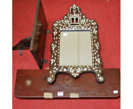 A Moorish hardwood and mother of pearl inlaid shaped wall mirror, together with two mahogany wall shelves (3)