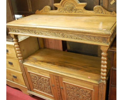 A circa 1900 floral relief carved oak ledgeback buffet, having bobbin turned supports over twin lower cupboard doors, width 1