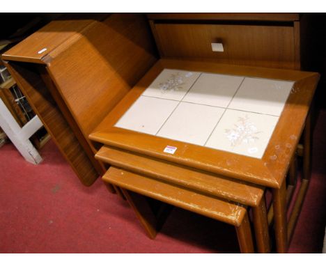 A teak and tile topped nest of three occasional tables, a teak drop leaf dining table, and a teak three drawer bedside chest 