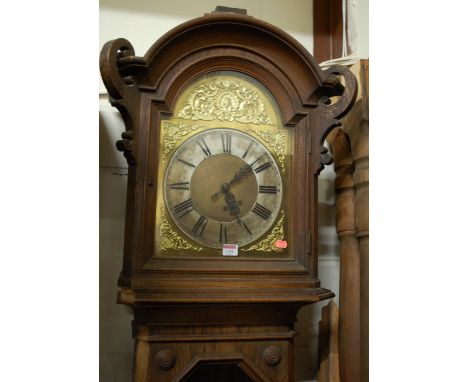 A circa 1900 Continental geometric moulded oak longcase clock, having an arched brass and silvered dial, glazed trunk door, w