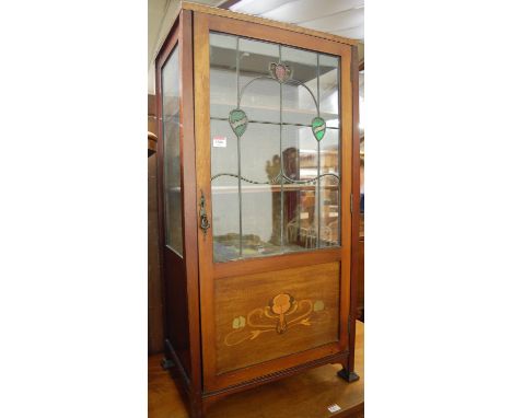 An Art Nouveau mahogany ledgeback and lead glazed single door china display cabinet, w.52.5cm. Top surface with ‘join line’ t